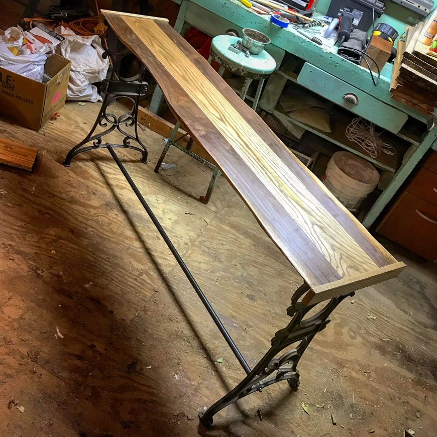 live edge walnut & oak console table with tv. homemade, diy, with cast iron legs from a sewing machine